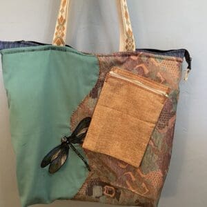 Teal tote bag with dragonfly and pocket.