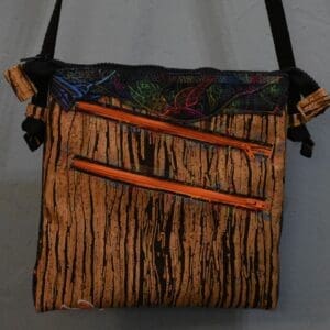 A bag with two handles and a strap.