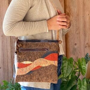 A woman is holding onto the strap of her purse