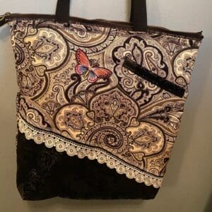 A brown and white bag with lace on it
