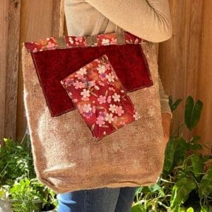 A woman holding onto a bag with flowers on it
