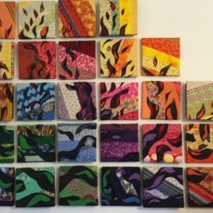 A wall with many different colored tiles on it
