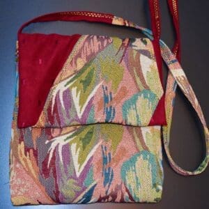 A purse that is sitting on the ground.