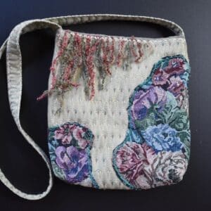 A bag with flowers on it sitting on top of a table.
