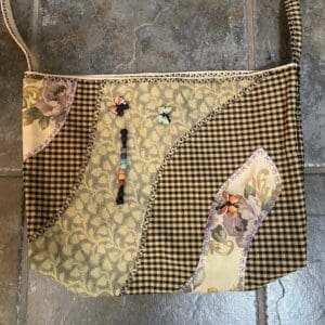 A purse that is made of fabric and has some decorations on it.