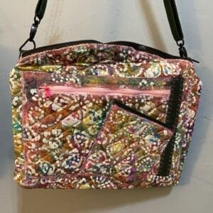 A purse that is sitting on the ground.
