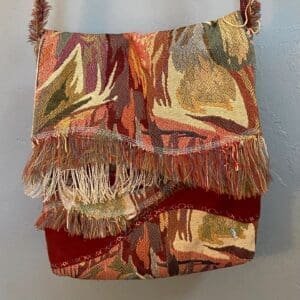 A bag with fringed edges and a red background