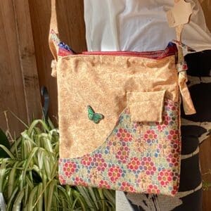 A woman is holding onto a bag with a butterfly on it.