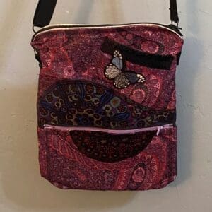 A pink bag with a butterfly on it